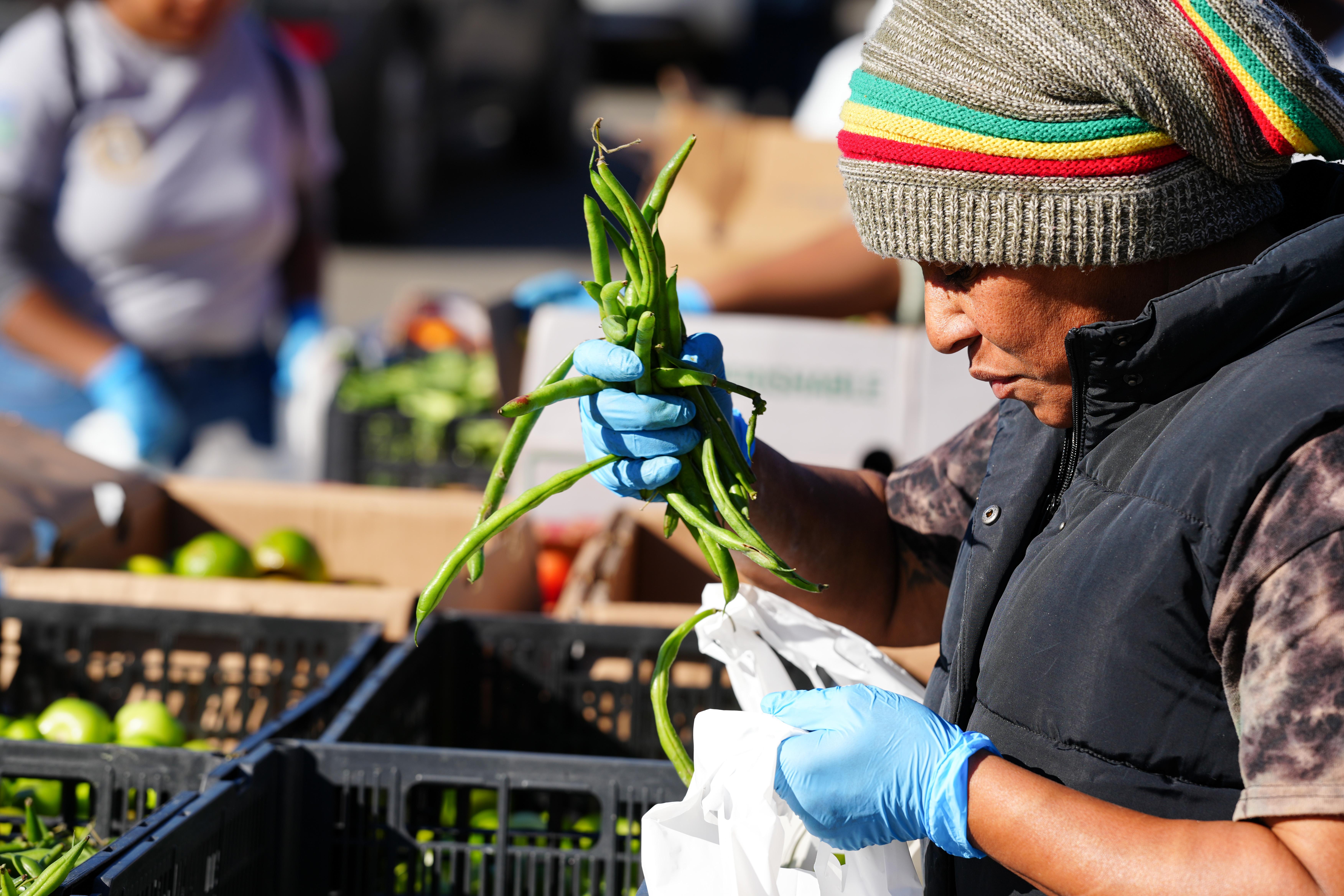 Person bagging vegetables